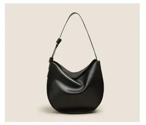 Detailed view of the black soft leather hobo shoulder bag featuring a smooth crescent shape.