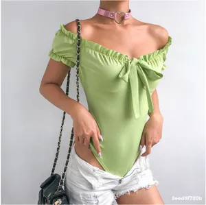 Detailed view of the light green off-the-shoulder bodysuit, featuring cute ruffles and front bow.