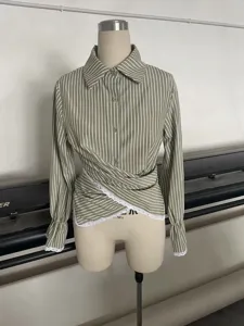 Chic striped long sleeve blouse with elegant crossover waist and delicate lace trim details.