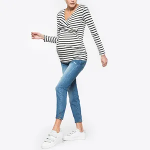 Black and white striped V-neck long sleeve maternity nursing top detail shot, showing crossover style.