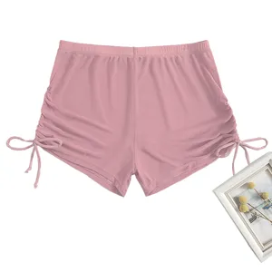 Close-up details of the pink mesh high-waisted swim shorts featuring adjustable side drawstrings.
