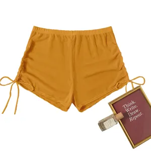 Detail view of women solid yellow mesh high waist drawstring swim shorts beach bikini bottoms.