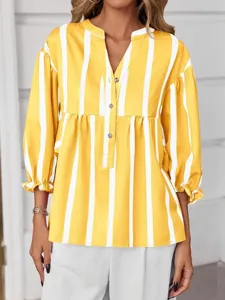Detail view of women's yellow and white striped V-neck blouse with bubble sleeves and buttons.