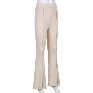 Close-up detail of beige casual flare pants with vertical seam line design, elegant style.