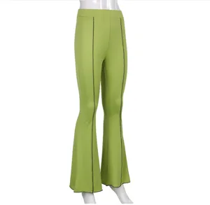 Detail shot of solid green casual flare pants featuring contrast front seam design and high waist.