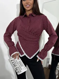 Detail view of the stylish burgundy striped wrap blouse with elegant lace trim cuffs and hem.