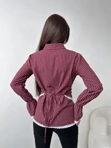 Detailed back view of a stylish maroon vertical striped long sleeve shirt with lace trim and waist tie.