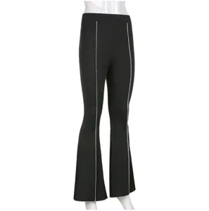 Detail view of black flare trousers featuring elegant silver side piping and high waistline.