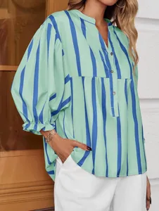 Green and blue striped blouse detail, featuring a stylish V-neckline and chic puff sleeves.