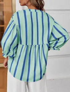 Detailed view of the green and blue striped blouse showcasing the elegant puff sleeves and relaxed fit.