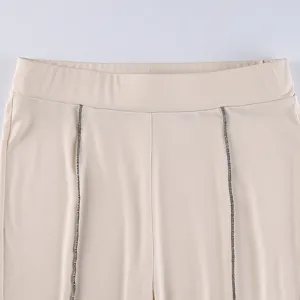 Close-up detail of women casual pants waistband design with stylish contrast stitching.