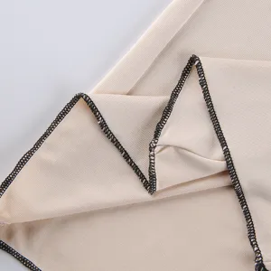 Close-up detail of women's casual trousers fabric showing neat black overlock stitching.
