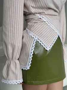 Striped long sleeve wrap blouse with delicate white lace trim and chic crossover waist design.