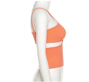 Side view of an orange ribbed cutout halter crop top on a white mannequin, showing detail.