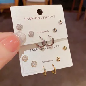Detailed close-up of gorgeous zircon square stud and small hoop earrings set for daily wear.