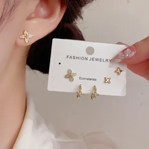 Detail view of chic zircon star stud earrings and hoop set, elegant daily wear jewelry.
