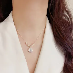 Vista di dettaglio di una collana con ciondolo in perle e zircone e catenina elegante.