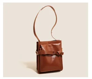 Brown patent leather shoulder bag detail, vintage commute daily handbag with knot belt design