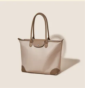 Spacious nylon shoulder bag with leather details, perfect for daily commute and casual use.