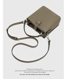 Sac seau en cuir élégant pour femme, bandoulière et sac à main gris en détail.