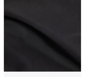 Black oxford cloth backpack fabric texture detail view showcasing durable material quality.