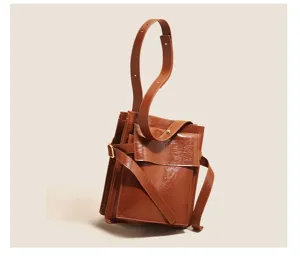 Brown patent leather shoulder bag detail, vintage commuting daily handbag with multi pocket design.
