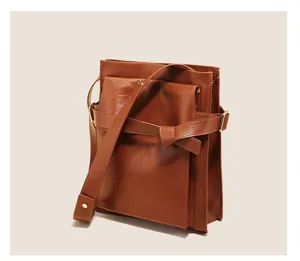 Brown PU leather shoulder bag with chic belt decor and metal hardware, stylish detail view.