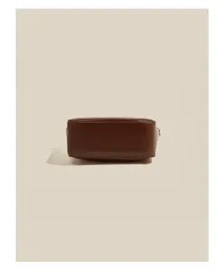 Brown oil-wax leather shoulder bag bottom detail shot, premium classic vintage style accessory.
