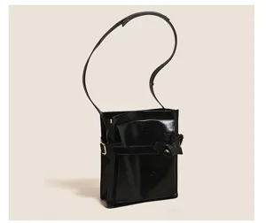 Stylish black patent leather shoulder bag with chic belt detail for women daily commute.