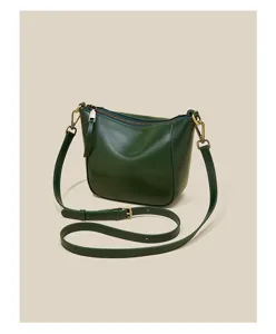 Close-up detail of dark green oil wax leather women shoulder bag hardware and adjustable strap.