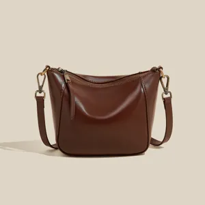 Genuine leather shoulder bag for women, simple casual crossbody handbag with zipper closure.