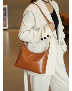 Brown leather underarm bag detail shot, chic casual shoulder handbag for women daily commuting.