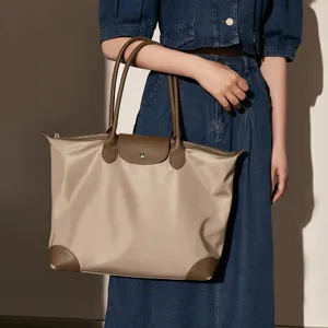 Large capacity nylon tote bag with leather trim, stylish commuter shoulder bag for women.