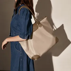 Stylish lightweight waterproof nylon tote shoulder bag with brown leather trim for women.