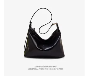Black leather underarm shoulder bag for women, stylish large capacity casual commuter handbag.