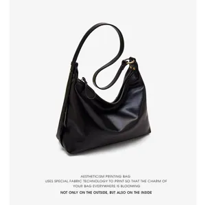 Classic black leather shoulder bag for women, stylish hobo design for daily commuting and casual wear.
