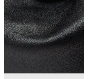 Close-up detail view of premium black genuine leather texture, showcasing fine grain craftsmanship.