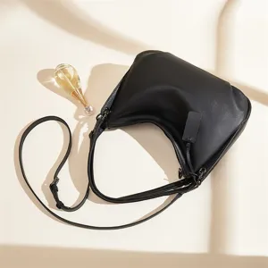 Black genuine leather shoulder bag for women, stylish crossbody handbag with adjustable strap.