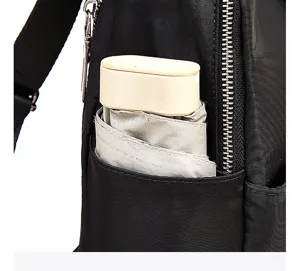 Black backpack side pocket detail view showing durable oxford fabric and neat stitching.