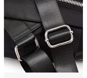Durable black nylon backpack detail showing metal adjustable buckles and sturdy straps.