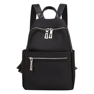 Fashion black nylon backpack for women, casual school bag with multiple zipper pockets.
