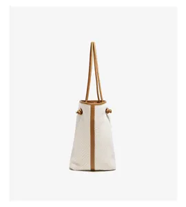 Canvas bucket shoulder bag with brown leather trim and side knot detail chic design