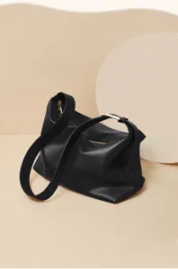 Close-up of black genuine leather hobo shoulder bag with soft leather and sleek metal hardware.