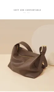 Close-up detail of brown soft leather hobo shoulder bag with metal zipper and buckle.