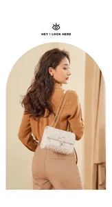 White quilted shoulder bag detail featuring golden chain strap and cute heart lock design.