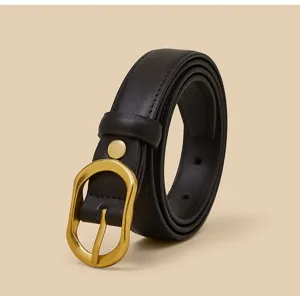 Detail view of a chic black leather belt for women, featuring a unique gold irregular metal buckle.