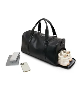 Detail view of the black travel duffel bag featuring a convenient side shoe compartment.