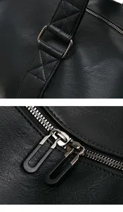 Men business travel bag detail close up showing durable faux leather and metal hardware design.