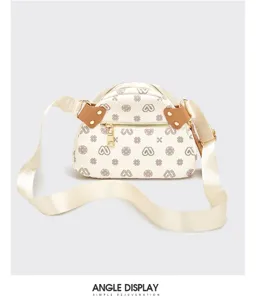 Detailed view of women's monogram crossbody bag featuring wide strap and hardware.