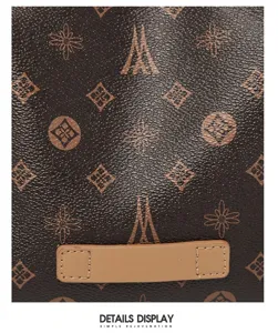 Brown leather shoulder bag detail with classic monogram pattern and contrast stitch patch for women